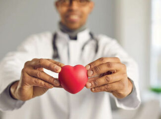 A doctor holding a heart in his hands