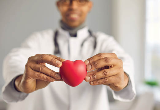 A doctor holding a heart in his hands