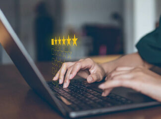 A woman typing on a computer with stars over the keyboard.