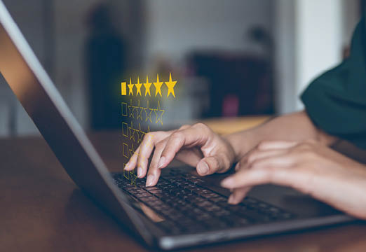 A woman typing on a computer with stars over the keyboard.