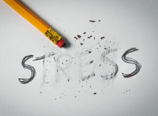 A pencil erasing the word 'stress' on a paper