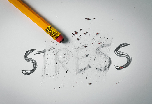 A pencil erasing the word 'stress' on a paper